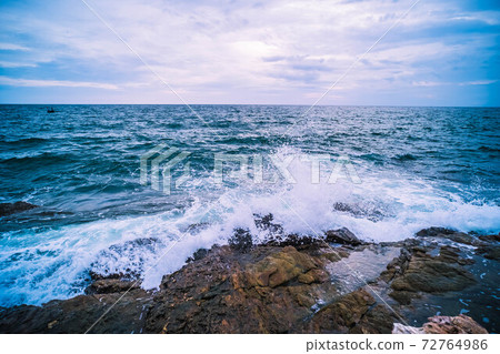 Sea Ocean with Smooth Wave and Rock landscape with blue sky. Nature of Seascape vacation time. 72764986