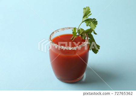 Glass of Bloody Mary on blue background 72765362