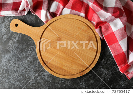 Kitchen towel and wooden board on black smokey background Kitchen towel and wooden board on black smokey background 72765417