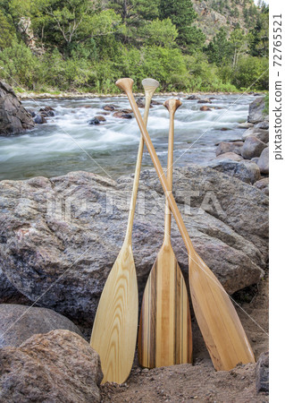wooden canoe paddles and mountain river 72765521