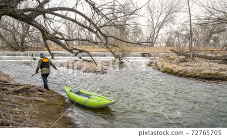 paddler with whitewater inflatable kayak paddler with whitewater inflatable kayak 72765705