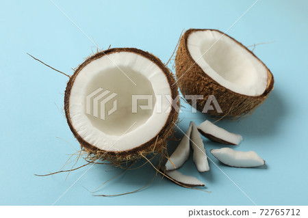 Fresh tasty coconut on blue background, close up 72765712