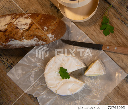 Camembert cheese on a wooden background 72765995