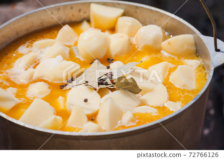 Soup with potato boils in a cauldron, close up Soup with potato boils in a cauldron, close up 72766126