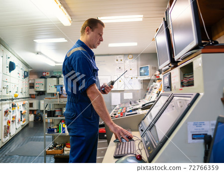 Marine Engineer working on radio communication at Engine Control room ECR 72766359