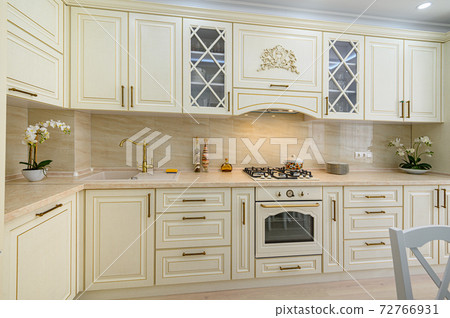 Beige furniture at kitchen in provence style, front view 72766931