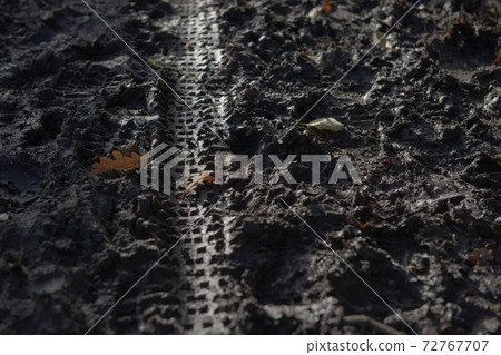 2 - Lighter footprints and bike tracks in deep winter season mud. 72767707