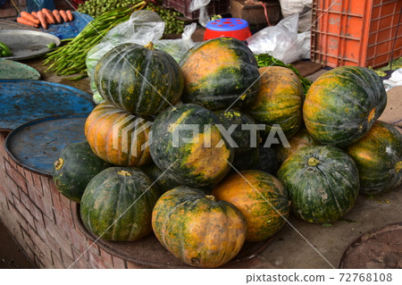 A vegetable market near Shodolgat at the dock in Dhaka, Bangladesh, a stall selling fine pumpkins 72768108