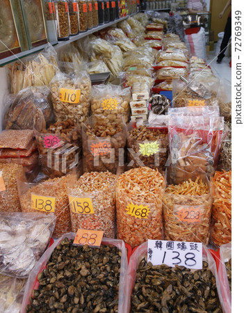 A shop that sells dried scallops, dried shrimp, and salt-dried fish in the west of Des Voeux Road, Hong Kong. In the foreground are dried oysters made in Korea and Japan. A shop that sells dried scallops, dried shrimp, and salt-dried fish in the west of Des Voeux Road, Hong Kong. In the foreground are dried oysters made in Korea and Japan. 72769349
