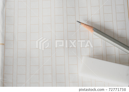 Pencil and eraser placed on the manuscript 72771738