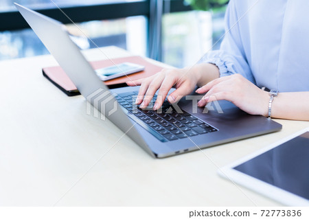 Hands of a woman operating a laptop indoors Hands of a woman operating a laptop indoors 72773836