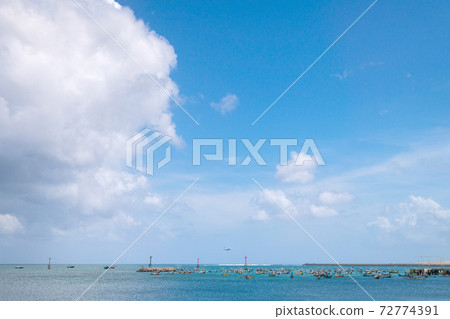Runways and planes across the sea where many ships float 72774391