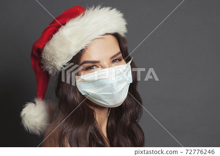 Christmas model woman Santa in protective medical mask 72776246