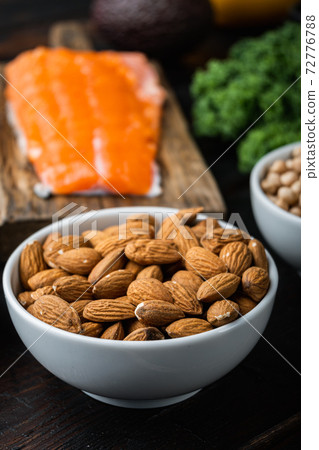 Almonds nuts with healthy food on dark wooden background Almonds nuts with healthy food on dark wooden background 72776788