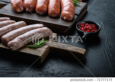 Traditional raw chicken sausages, on black background 72777173