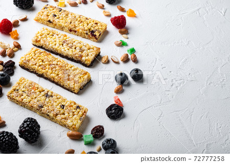 Various healthy granola, muesli and cereal bars with space for text, on white background Various healthy granola, muesli and cereal bars with space for text, on white background 72777258