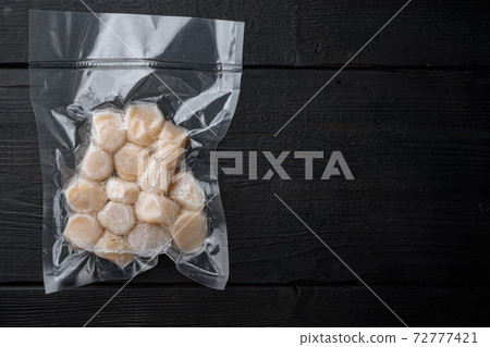 Frozen meat scallop in vacuum package, flat lay with space for text Frozen meat scallop in vacuum package, flat lay with space for text 72777421