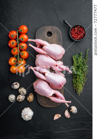 Homemade eco friendly raw quails, top view, on black textured background Homemade eco friendly raw quails, top view, on black textured background 72777477