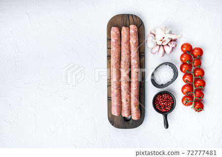 Traditional raw beef sausages, top view with space for text, on white background Traditional raw beef sausages, top view with space for text, on white background 72777481