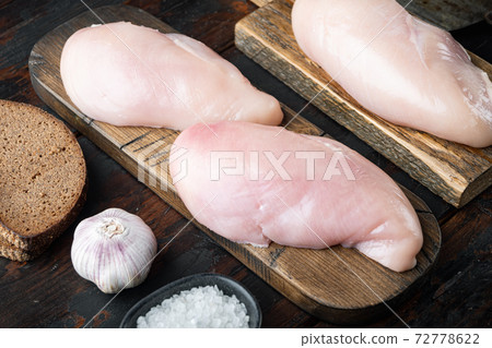 Raw crumbet chicken fillet with ingredients on dark wooden background 72778622