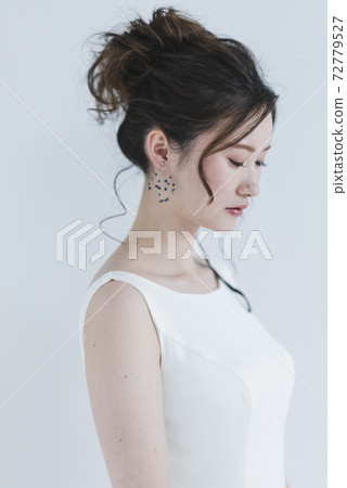 Bride wearing a wedding dress Bride wearing a wedding dress 72779527