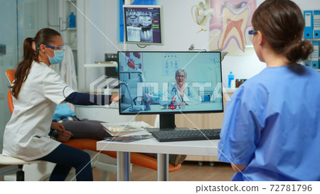 Assistent having video call with expert stomatologic doctor 72781796