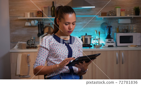 Freelance using tablet working overtime at home Freelance using tablet working overtime at home 72781836