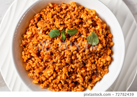 ground beef risotto bolognese in a bowl 72782439