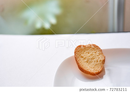 A rusk placed on a white plate A rusk placed on a white plate 72783211