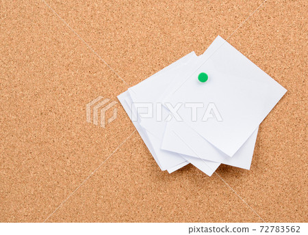 white square blank pieces of paper pinned on a cork board 72783562
