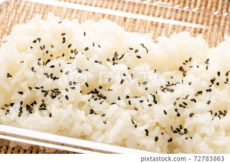 Rice sprinkled with salt and pepper in a take-out container. 72783863