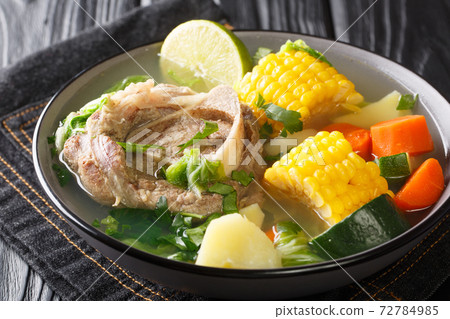 Delicious Caldo de res Mexican beef shank soup with vegetables close-up in a bowl on the table. horizontal Delicious Caldo de res Mexican beef shank soup with vegetables close-up in a bowl on the table. horizontal 72784985