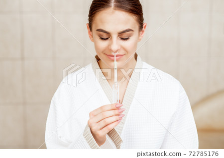 Woman receives nasal inhalation. 72785176