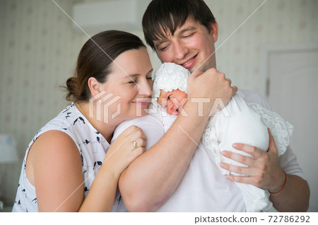 parents with a newborn in their arms. a man and a woman with long-awaited child. 72786292