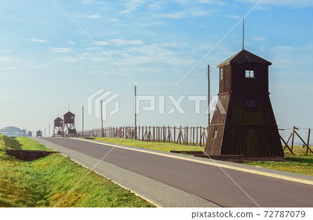 Road of Homage and Remembrance with barbed wire fences and a watchtowers in German concentration and extermination camp Majdanek. Lublin, Poland 72787079