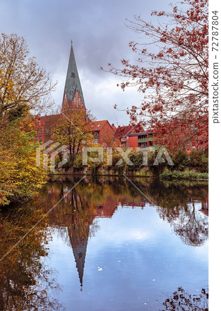 Luneburg, Germany, View of St. Johanniskirche with reflection in the river Luneburg, Germany, View of St. Johanniskirche with reflection in the river 72787804