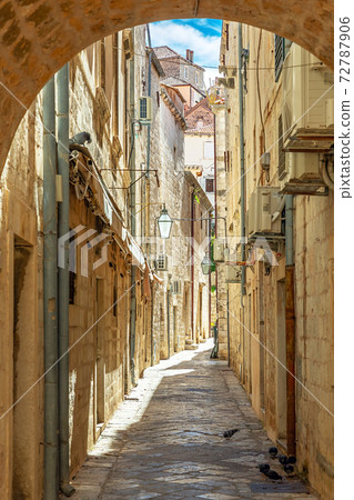 Dubrovnik, Croatia. Dubrovnik old street view with lanterns through the arch. Dubrovnik, Croatia. Dubrovnik old street view with lanterns through the arch. 72787906