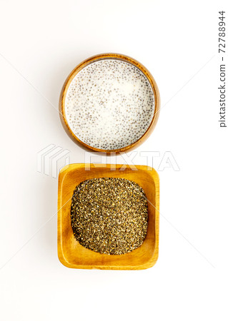 Chia seed milk pudding and dry seeds in bamboo bowls. Top view. Flat lay. Close up. Selective focus 72788944