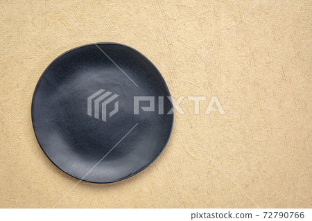 black plate on textured paper black plate on textured paper 72790766