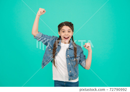Happy child celebrate victory making winning gesture keeping fists raised blue background, winner Happy child celebrate victory making winning gesture keeping fists raised blue background, winner 72790992