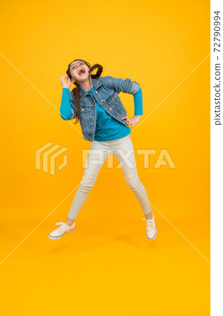 jumping smiling kid girl with stylish braided hair wearing jumping smiling kid girl with stylish braided hair wearing 72790994