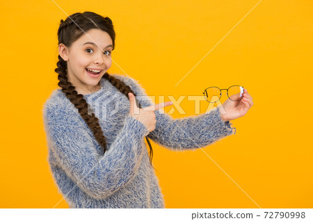smiling kid girl with stylish braided hair pointing finger smiling kid girl with stylish braided hair pointing finger 72790998