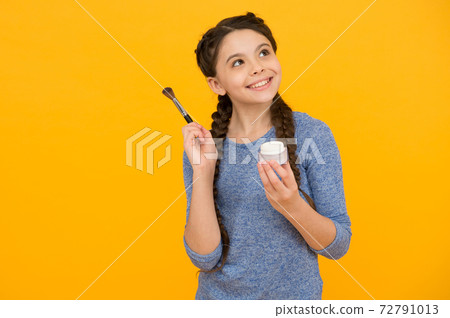 natural cosmetics for kids. happy little girl create her image. 72791013