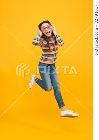 just dance. child jump in party glasses. happy childhood. 72791017