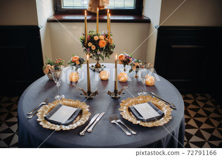 wedding table decoration with flowers on the table in the castle, table decor for dinner by candlelight.Dinner with candles 72791166