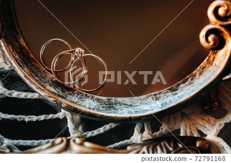 Close-up of two wedding gold rings engagement ring.Three rings.Wedding ring.Wedding 72791168