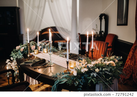 wedding table decoration with flowers on the table in the castle, table decor for dinner by candlelight.Dinner with candles 72791242