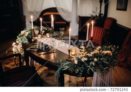 wedding table decoration with flowers on the table in the castle, table decor for dinner by candlelight.Dinner with candles 72791243