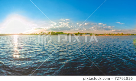 Panoramic view of the Kamenka river in the Zhytomyr region of Ukraine. Beautiful landscape of a large blue pond 72791836