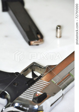 Chrome metal gun on white marble, powerful weapon Desert Eagle Chrome metal gun on white marble, powerful weapon Desert Eagle 72793000